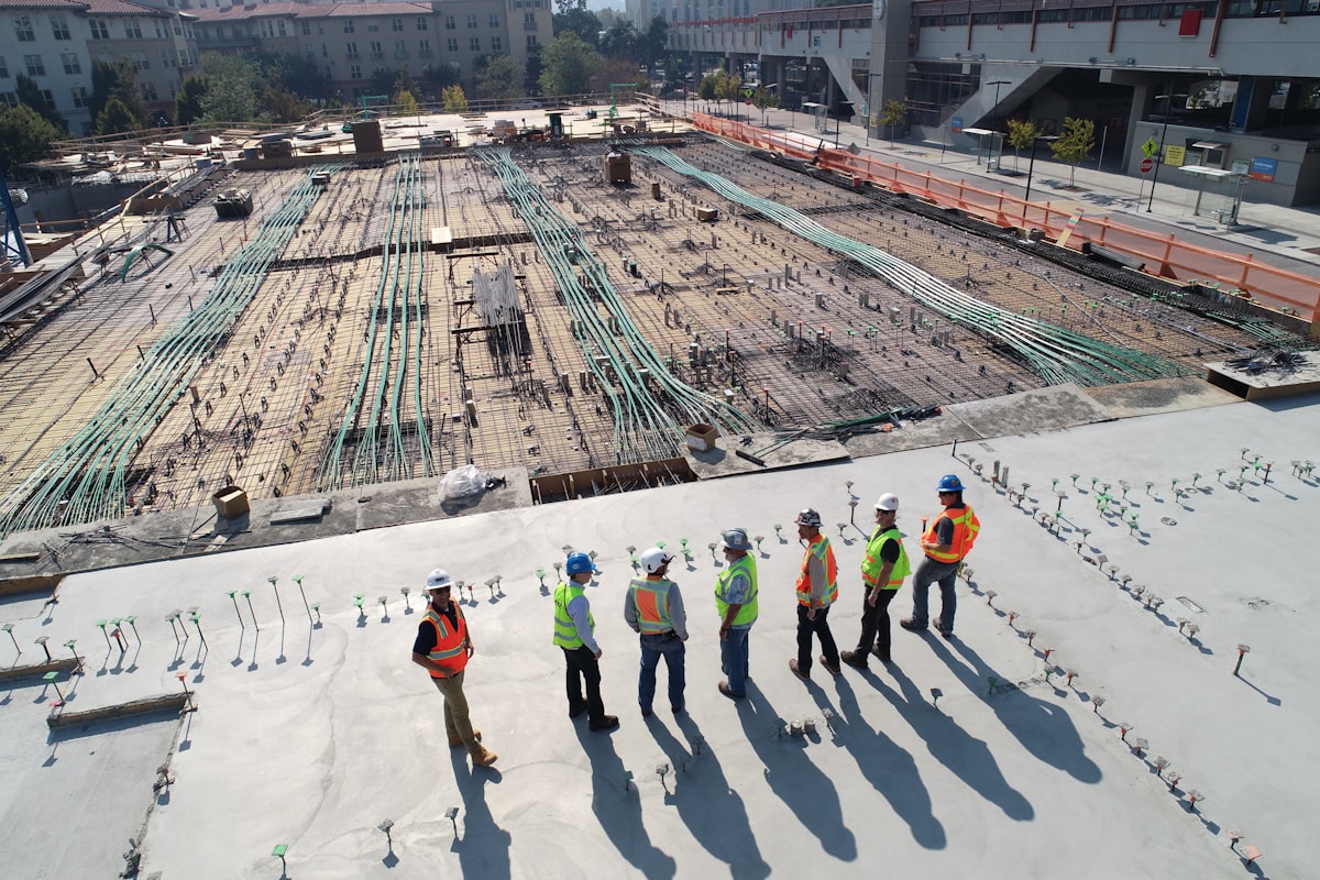 Construction site with engineers reviewing foundation and conduit layout